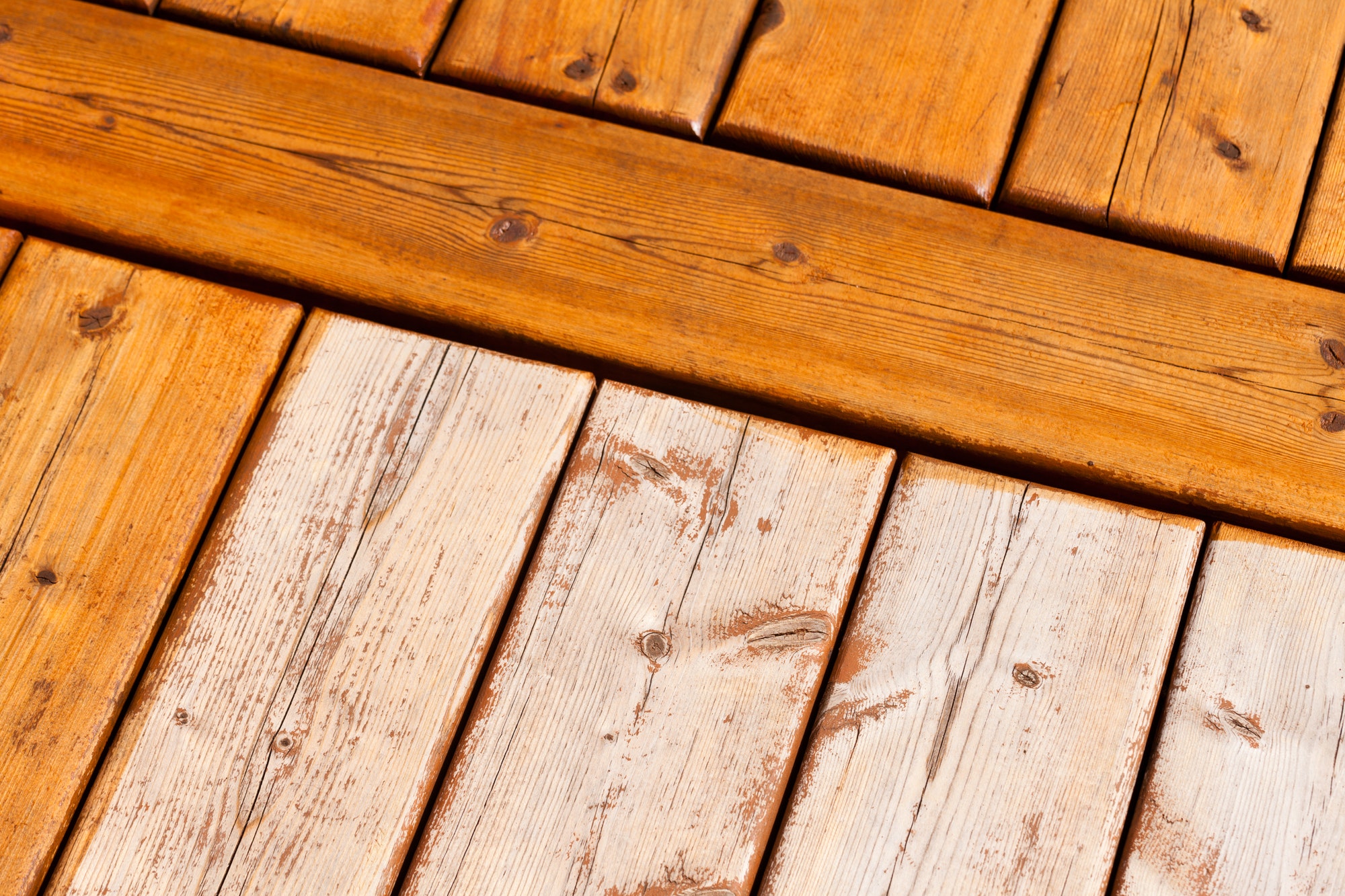 Wooden deck pattern partially stained transparent
